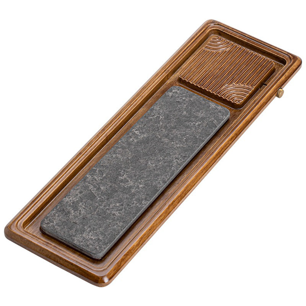 Elegant black stone tea tray with bamboo accents, showcasing its drainage feature.