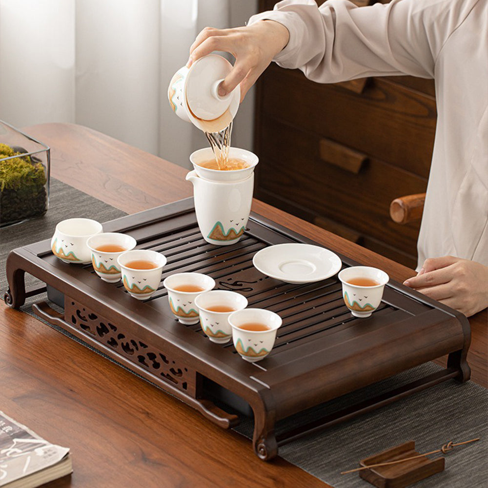 Tea ceremony setup featuring ebony tea tray with drainage pump for home use