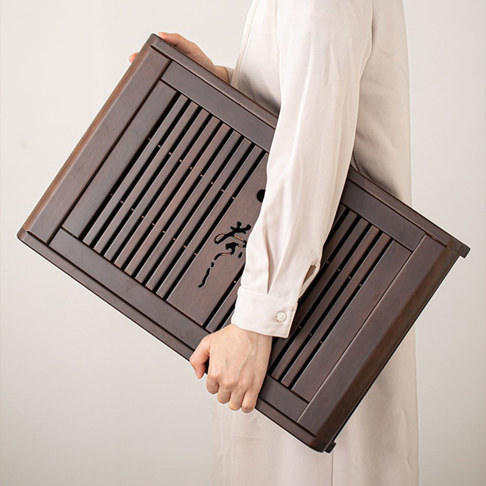 Tea ceremony setup featuring ebony tea tray with drainage pump for home use