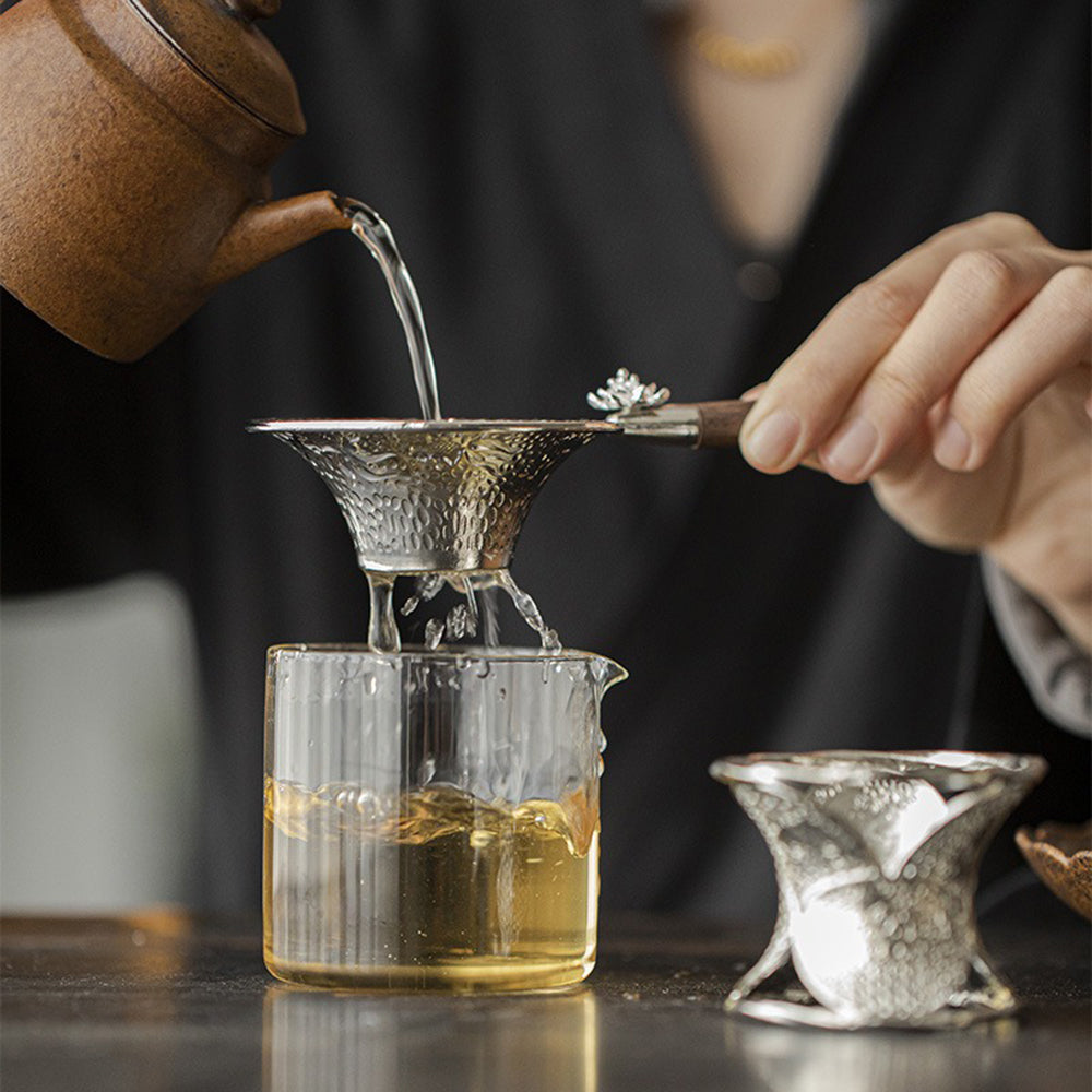 Elegant Lotus Goldfish Alloy Tea Strainer on a wooden table
