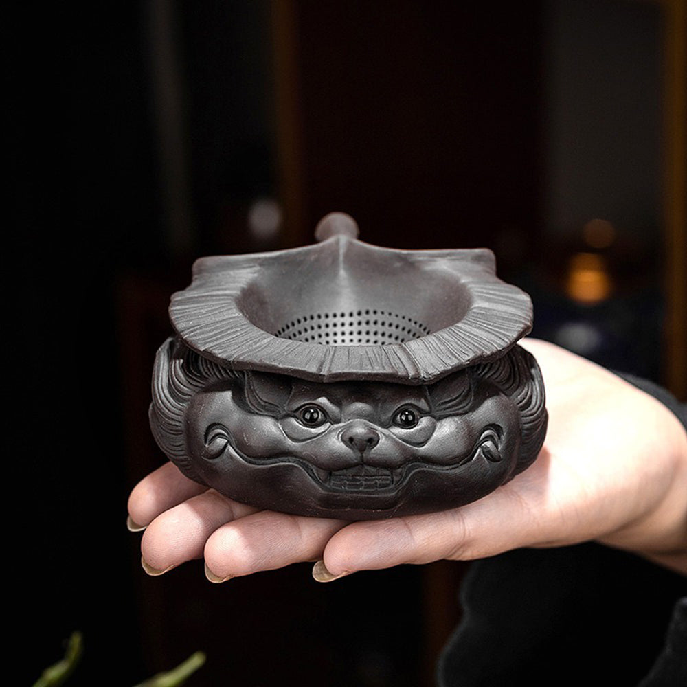 Majestic dragon tea strainer placed on a tea table, demonstrating its use in brewing tea.