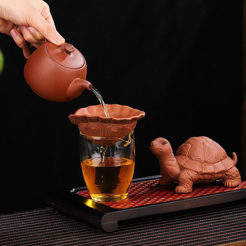 Turtle tea pet absorbing tea aroma, perfect for gongfu ceremonies.