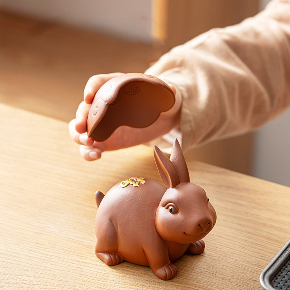 Use the purple clay tea infuser as a tea pet during a traditional tea ceremony