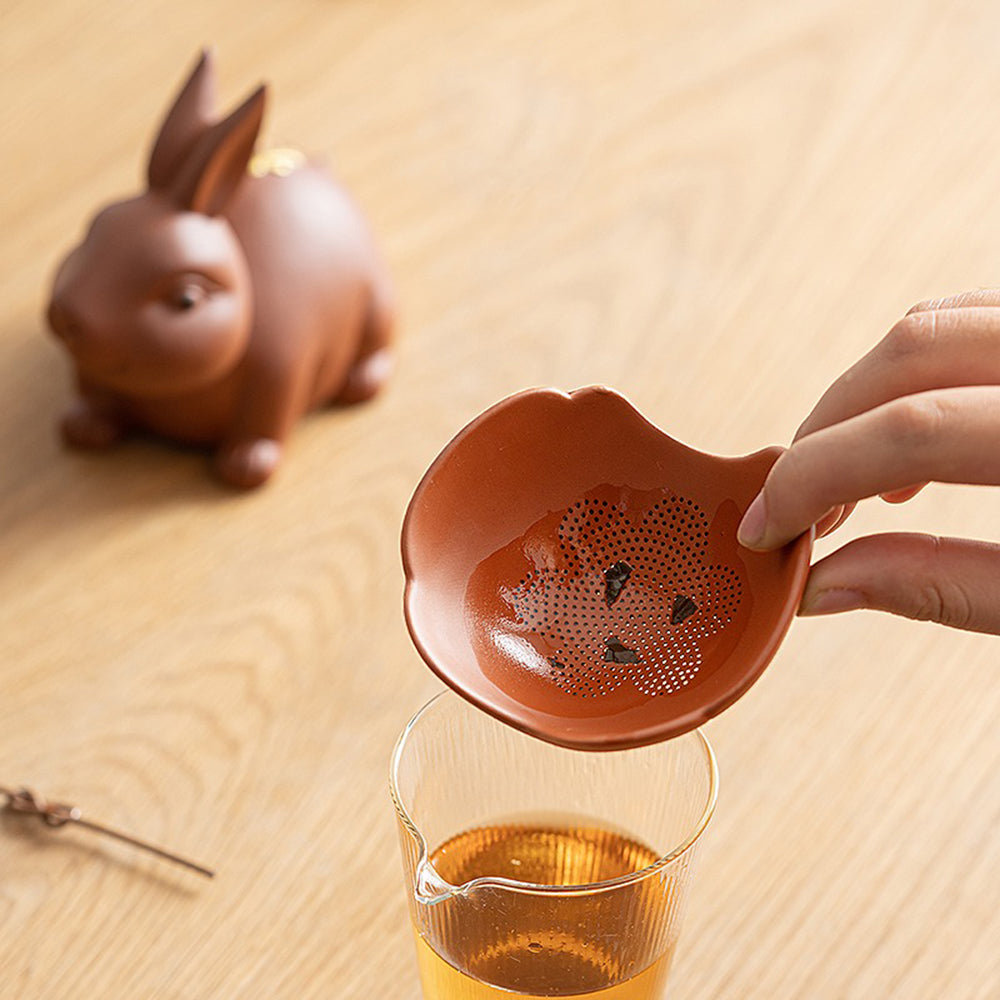 Close-up of the dense filter holes on the purple clay tea strainer for loose leaf tea