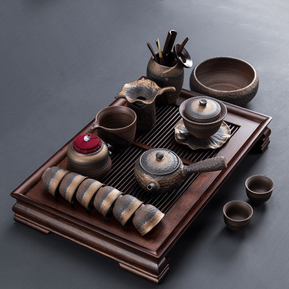 Close-up of handcrafted pottery gongfu tea set with natural glaze detail