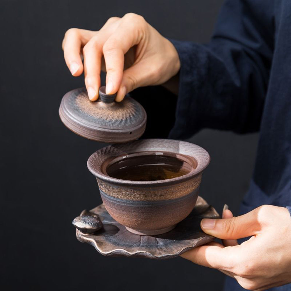 Close-up of handcrafted pottery gongfu tea set with natural glaze detail