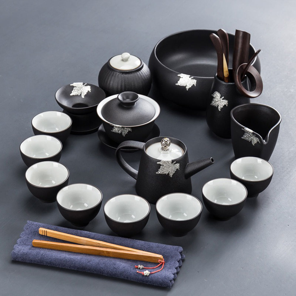 Detailed view of black pottery teapot and cups highlighting traditional craftsmanship