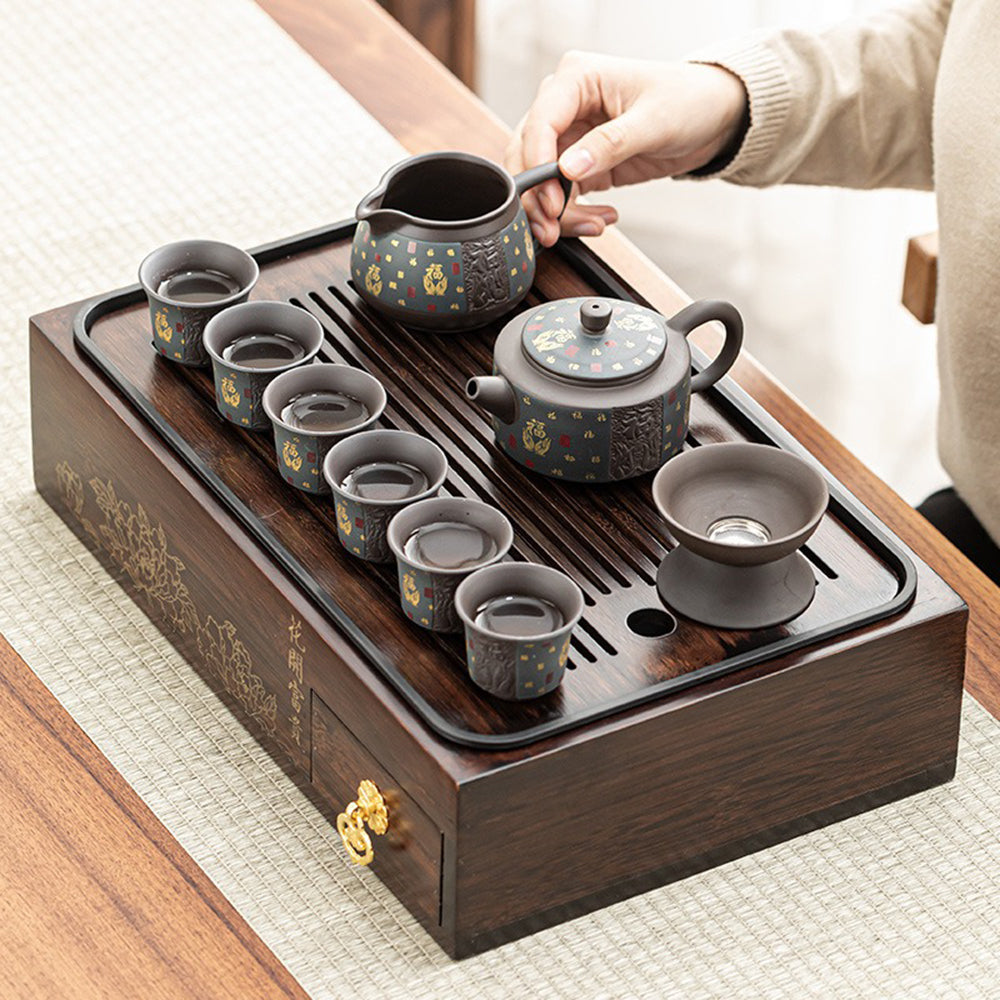 Elegant purple clay tea set displayed with bamboo storage box and drainage tray.