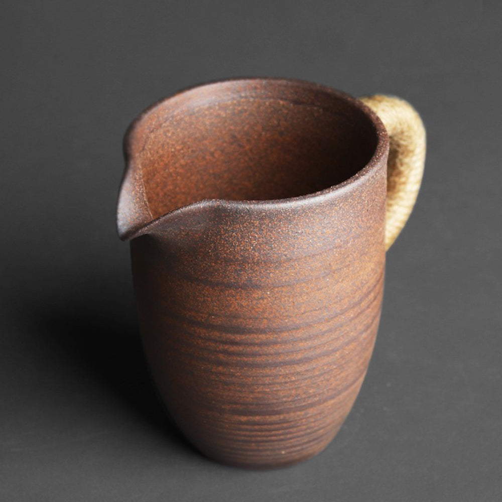 Side view of vintage coarse pottery fair cup, perfect for tea brewing.