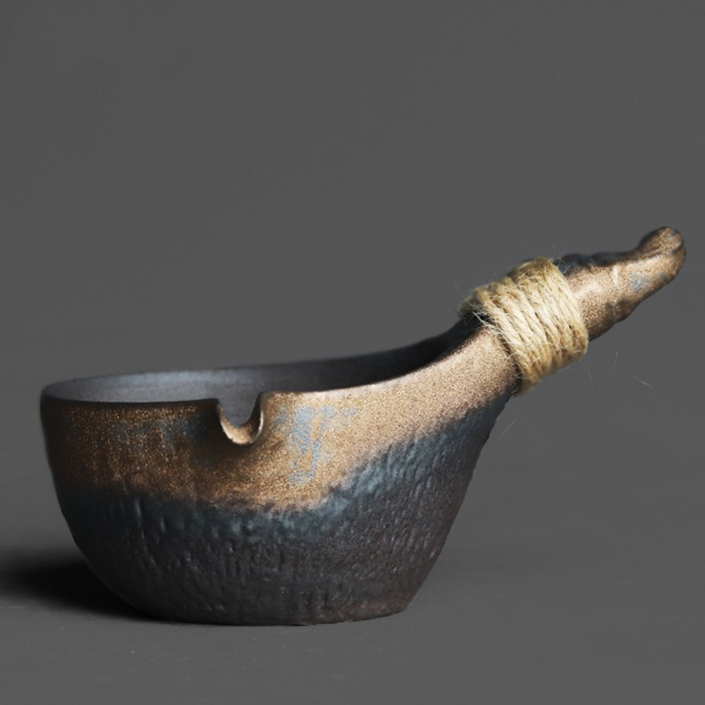 Coarse pottery fair cup with gilded finish and elegant design, perfect for tea brewing.