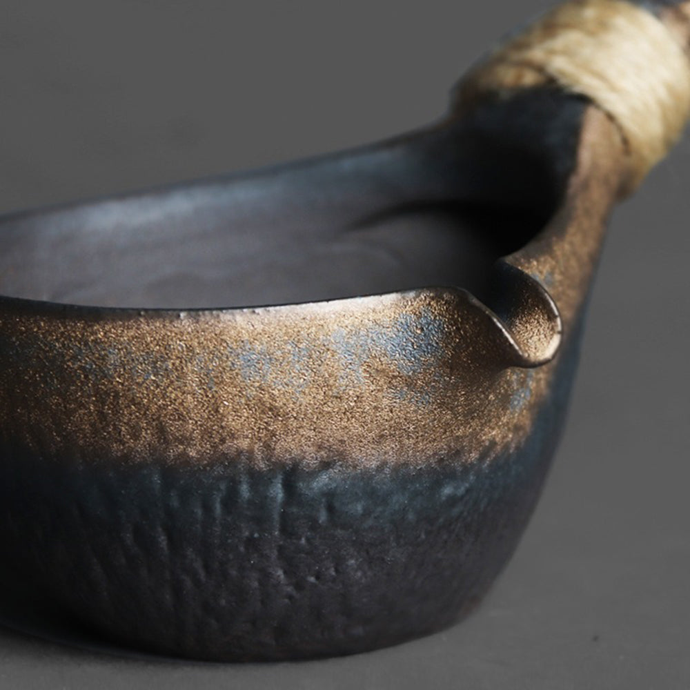 Close-up of the natural unglazed interior and polished bottom of the tea fair cup.