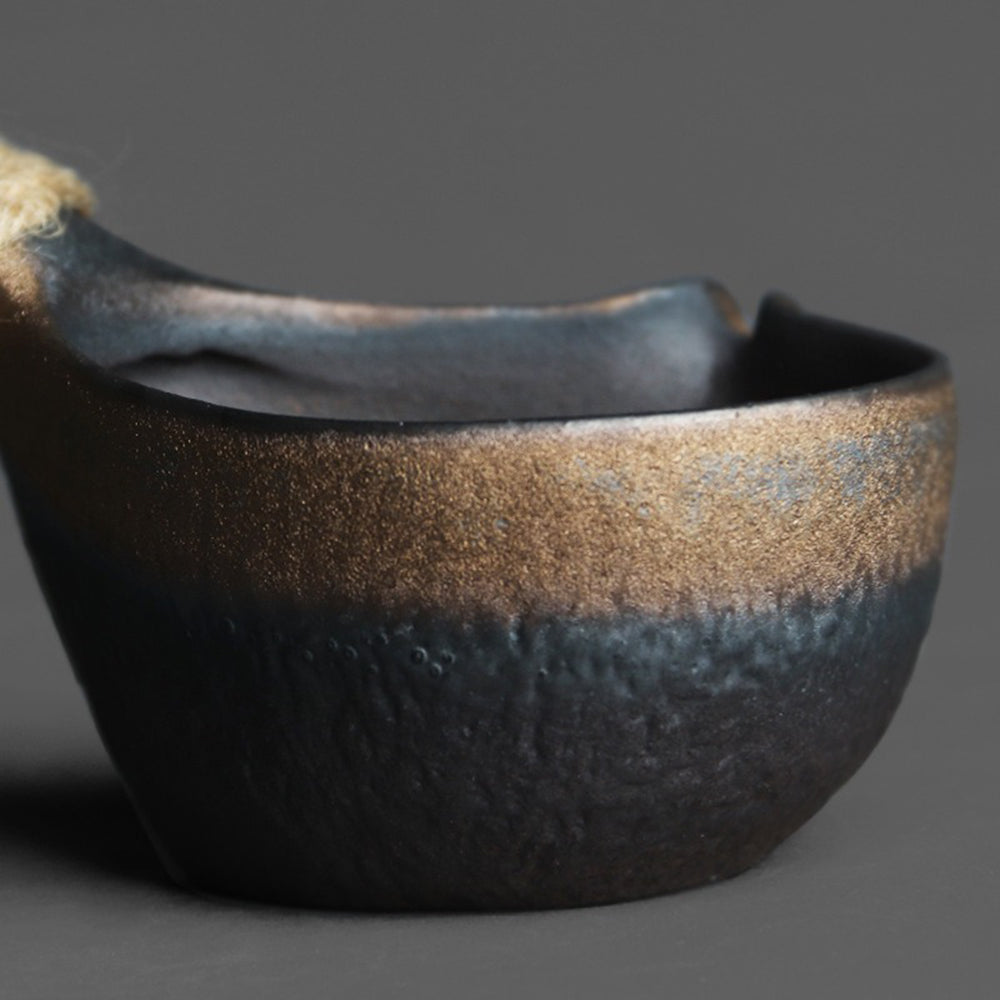 Coarse pottery fair cup with gilded finish and elegant design, perfect for tea brewing.
