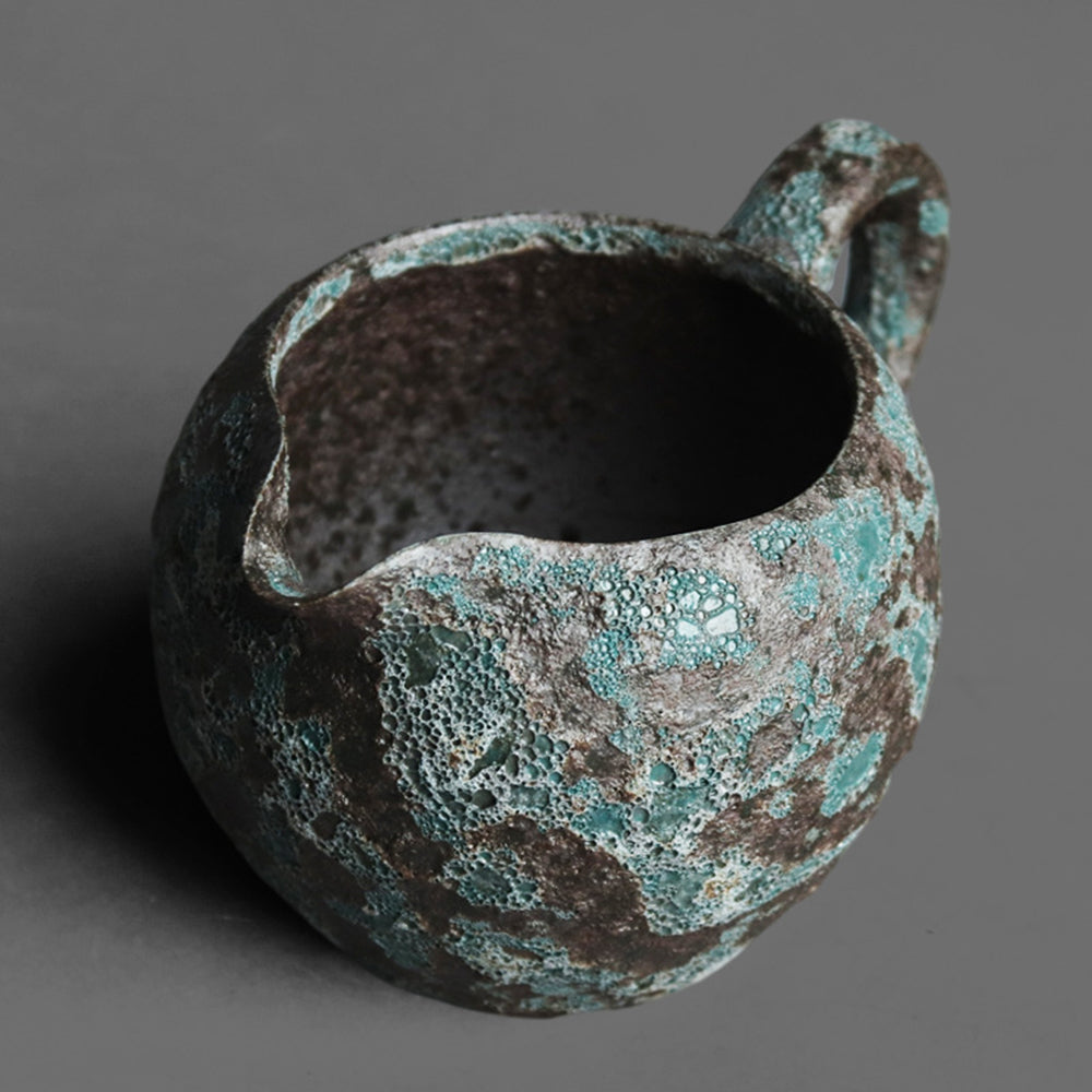 Side view of antique fair cup in a traditional tea setting