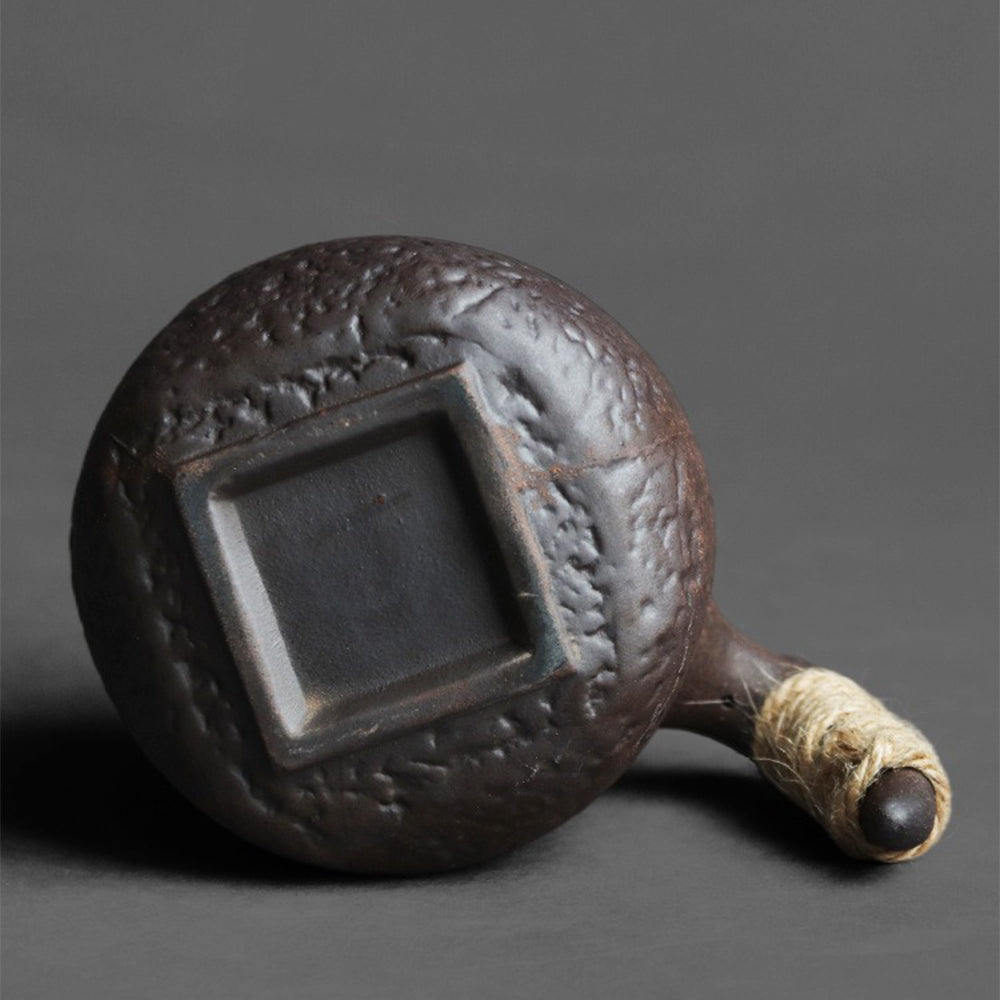Traditional Japanese ceramic tea cup with rope-wrapped handle for comfortable grip