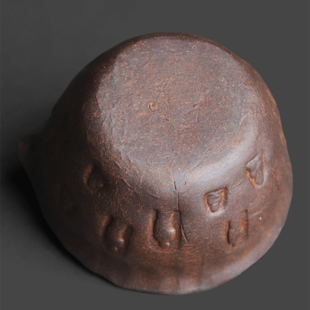 Handcrafted coarse pottery Zen tea cup with Buddha engraving, natural rustic finish