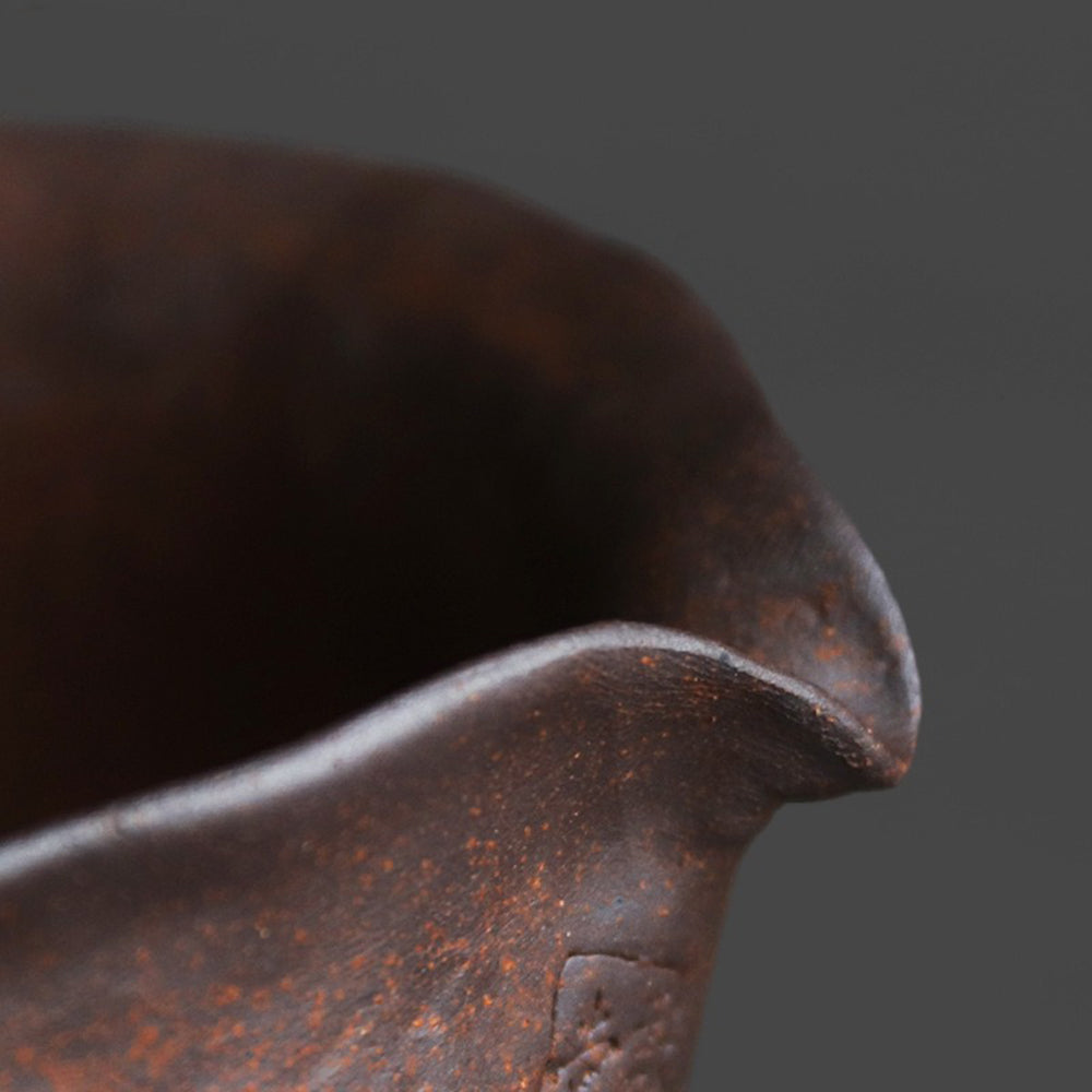 Close-up of the eagle beak spout on a handmade coarse pottery tea cup