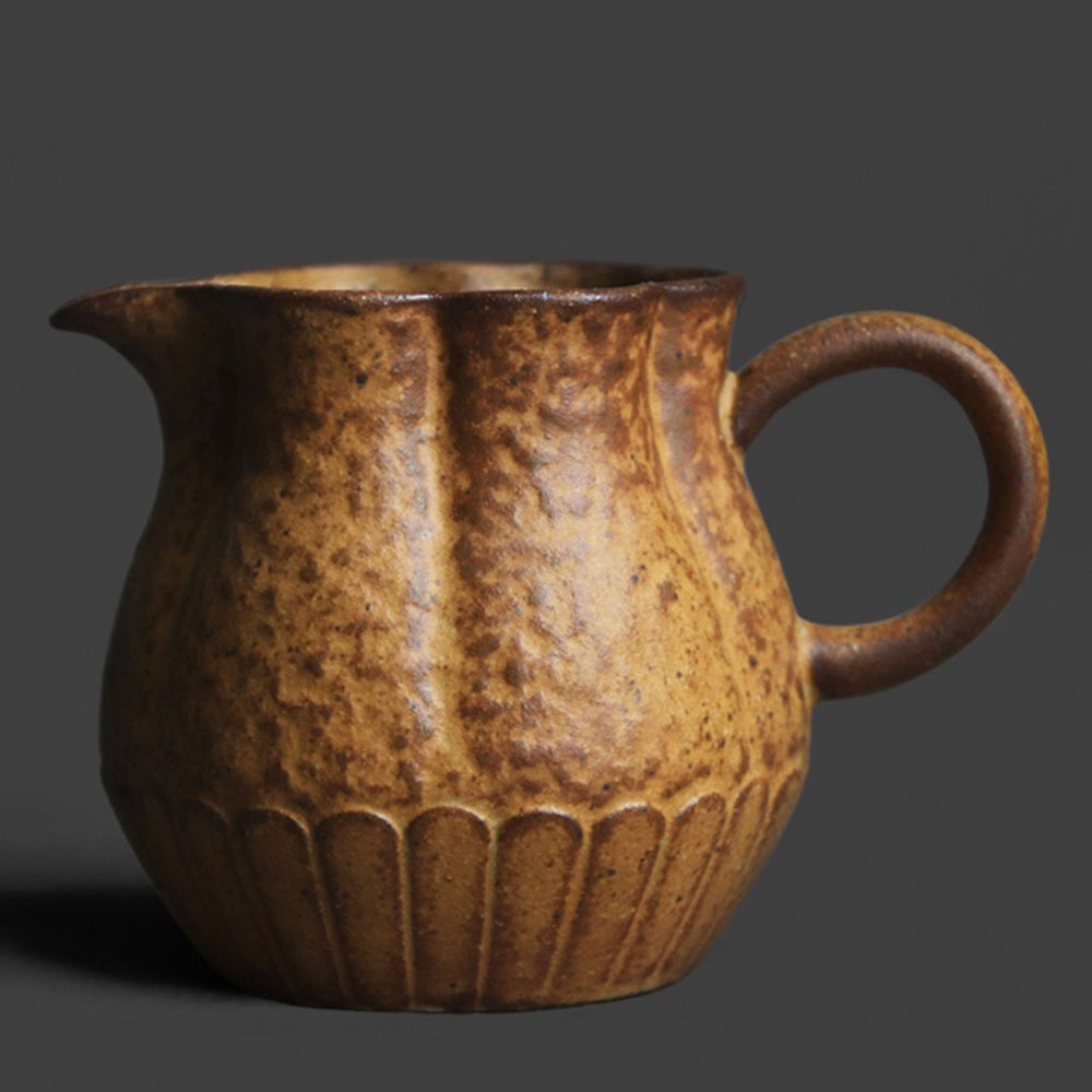 Overhead view of the sunflower-designed pottery cup showing its wide mouth and rustic glaze.