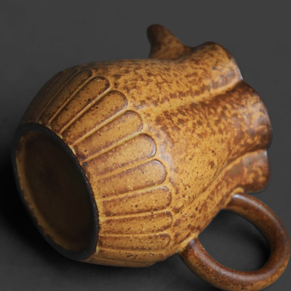 The pottery cup in a kitchen setting, filled with herbal tea — a beautiful piece for home use or gifting.