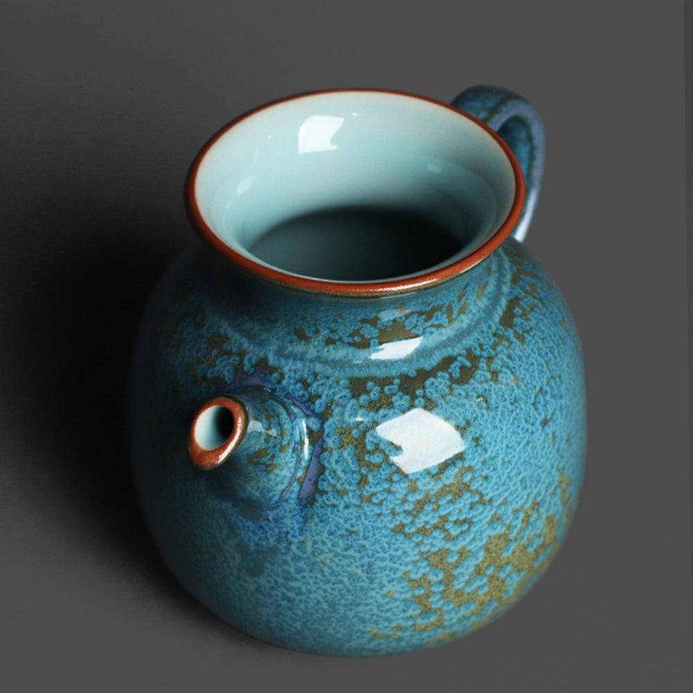 Tea brewing scene featuring the unique handmade ceramic fair cup on a wooden table
