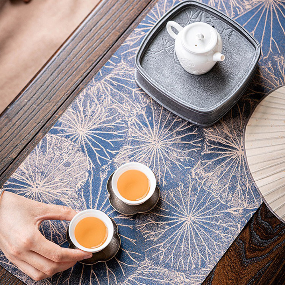 Tea set displayed atop brocade tea table mat, emphasizing its elegance and waterproof surface