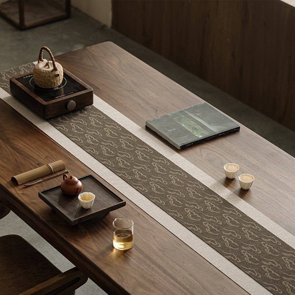 The Japanese tea mat displayed on a wooden tea table during a serene tea ceremony.