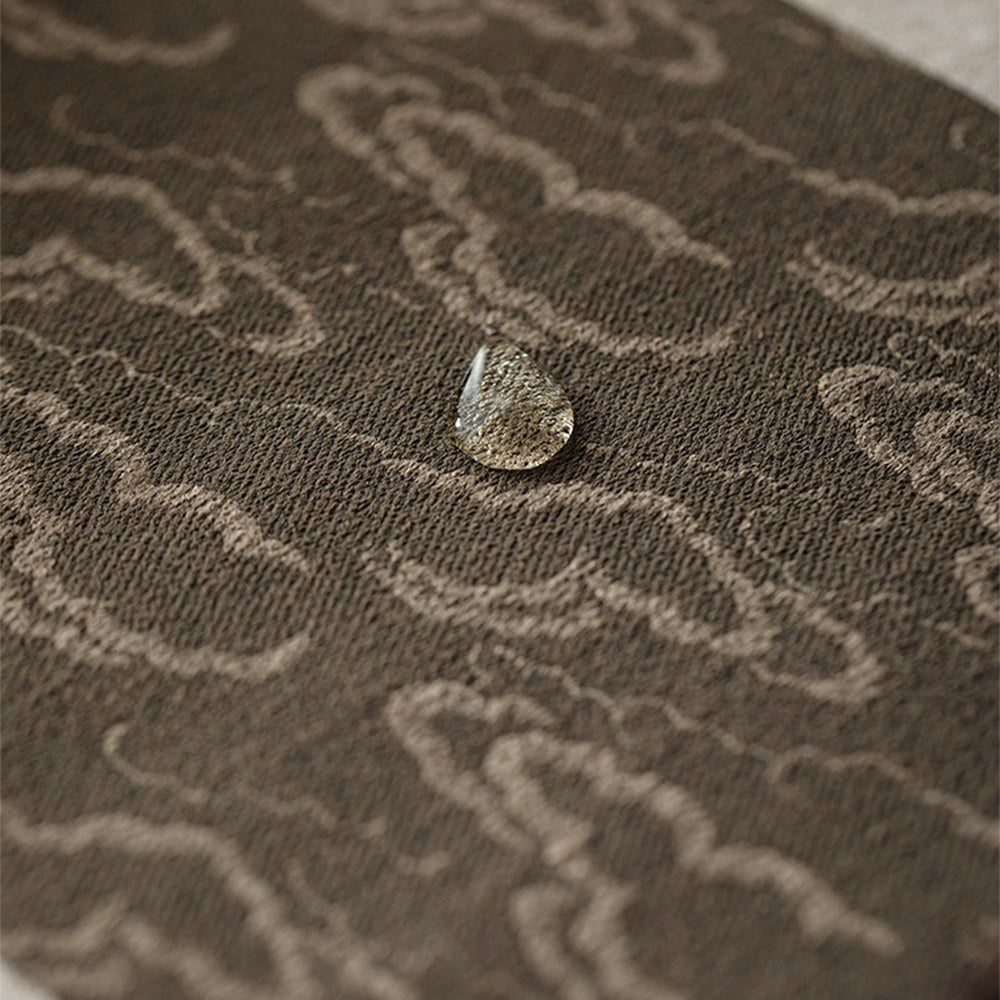 The Japanese tea mat displayed on a wooden tea table during a serene tea ceremony.
