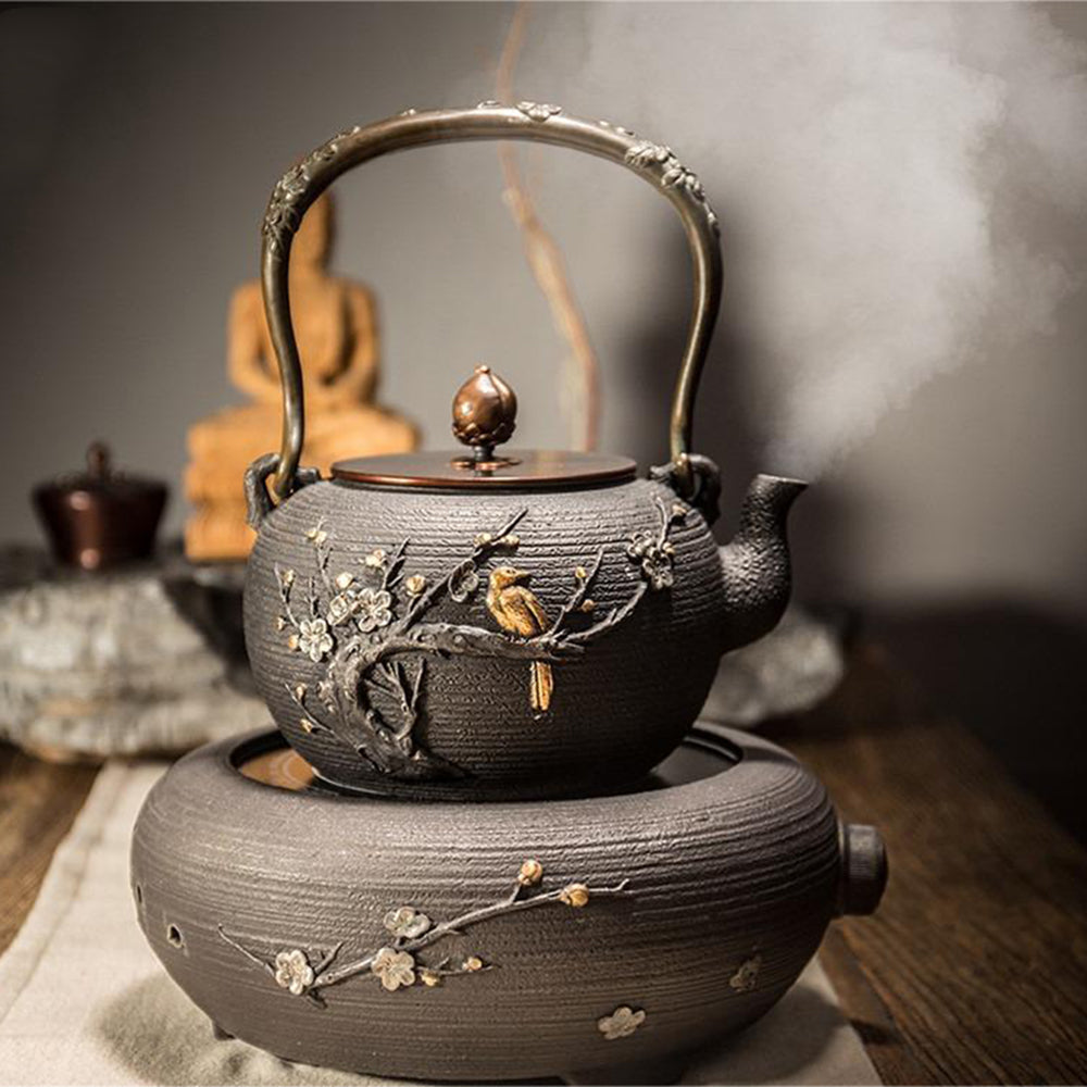 Elegant magpie cast iron teapot with induction cooker, perfect for tea brewing.