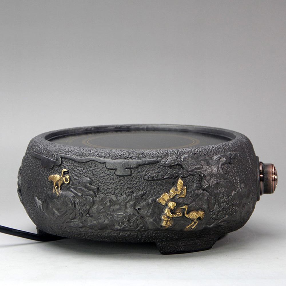 Elegant crane cast iron teapot with gilded pattern, showing spout and handle.