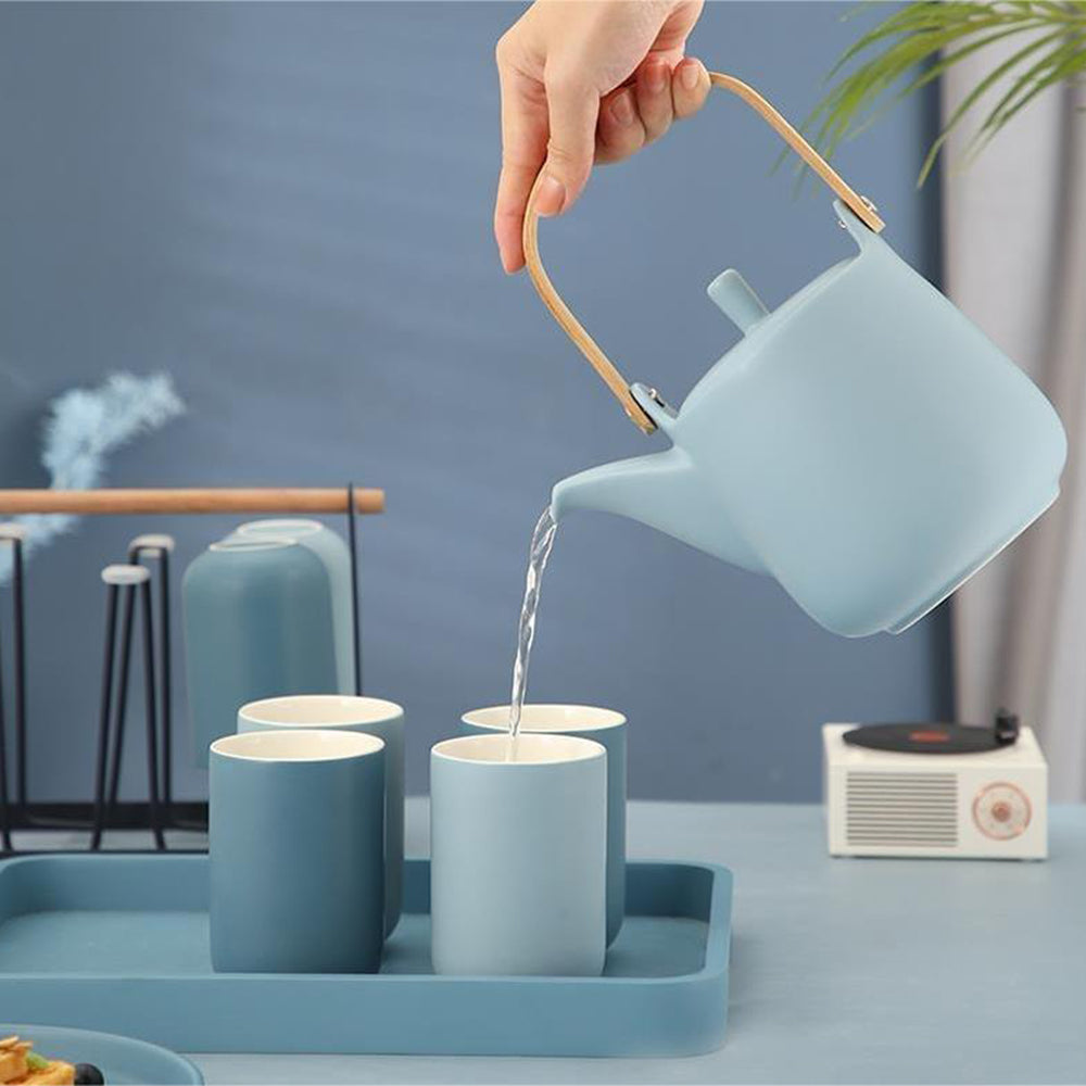Full assembled tea set displayed on iron rack in a home setting with natural lighting