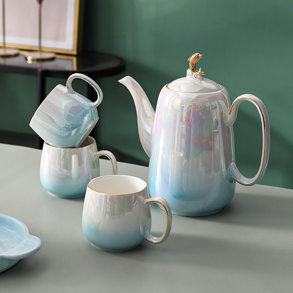 Ceramic tea set displayed on a tray, showcasing its vibrant gradient colors and design.
