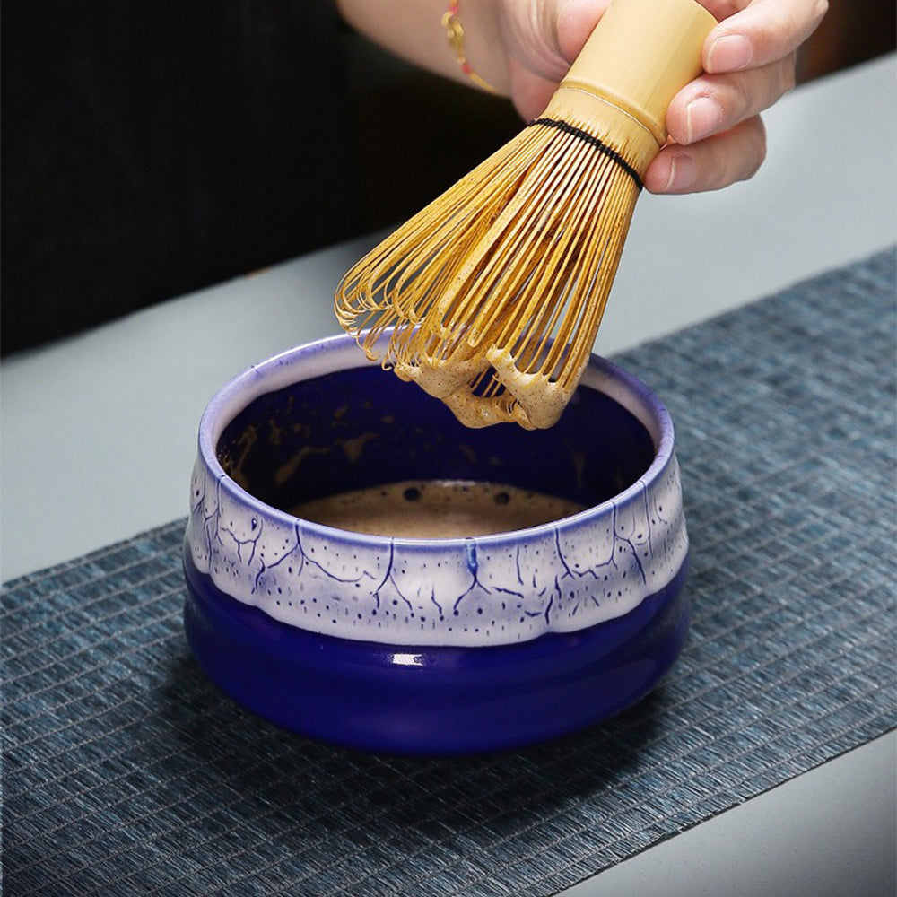 Close-up of matcha bowl and bamboo whisk in a portable travel case.