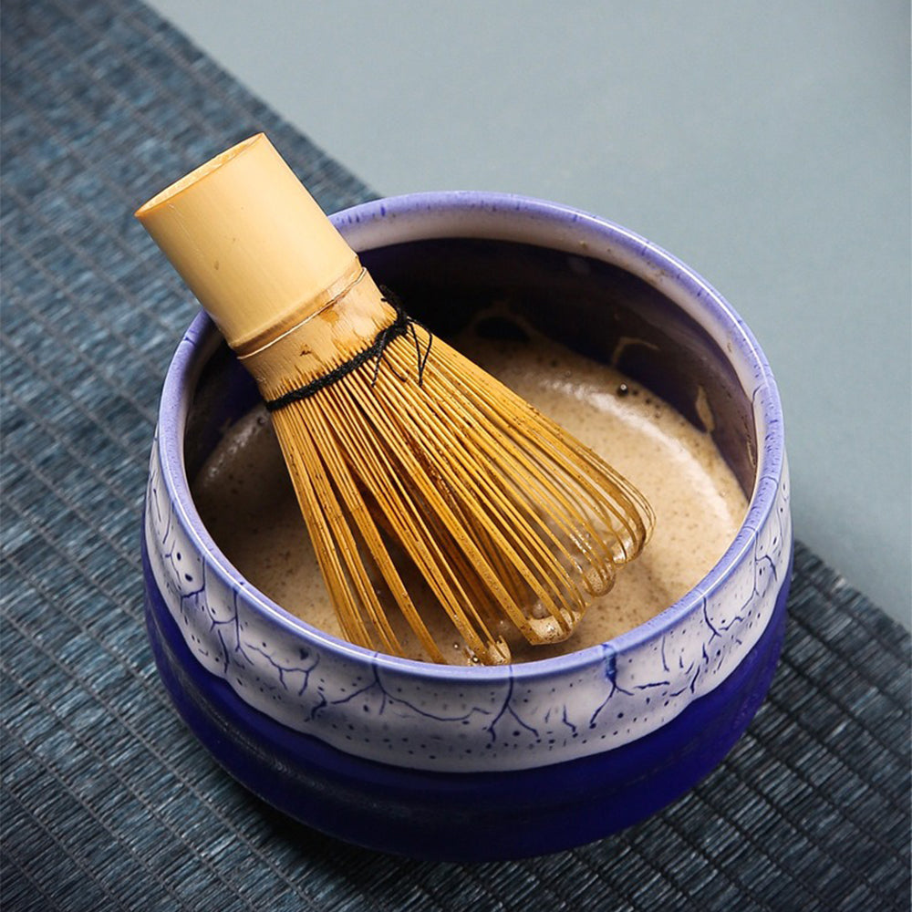 Artisan matcha tea set with travel bag, showcasing ceramic bowl and bamboo whisk.