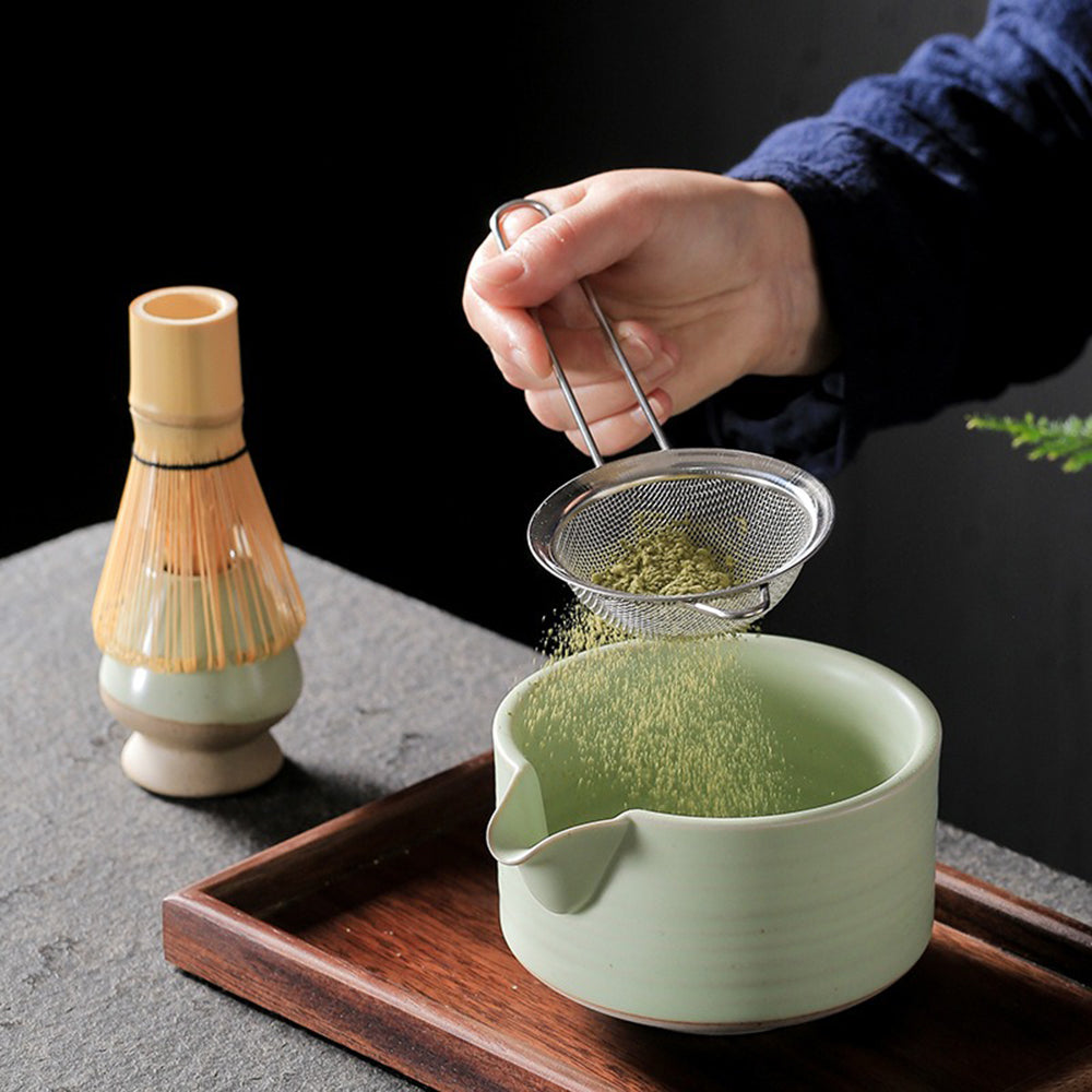 Elegant Japanese matcha bowl with bamboo whisk and accessories, perfect for tea ceremonies.
