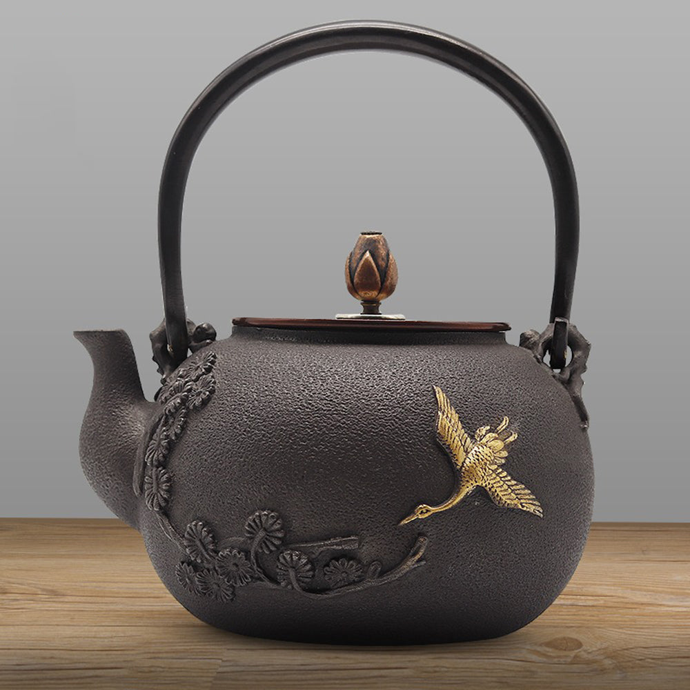 Side angle showing Japanese teapot’s gilded crane and pine engraving