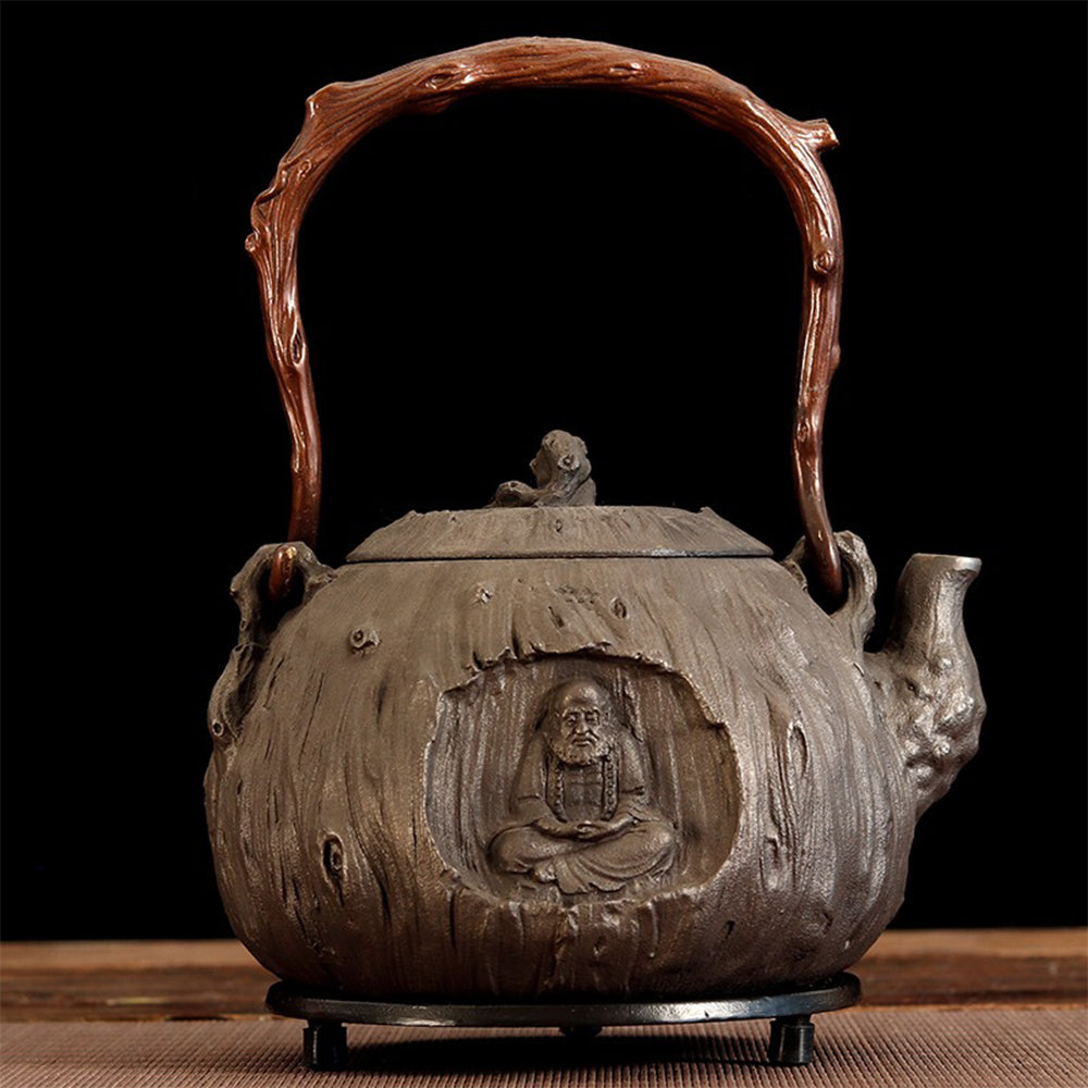 Close-up of Bodhidharma carving on Japanese cast iron teapot for tea brewing