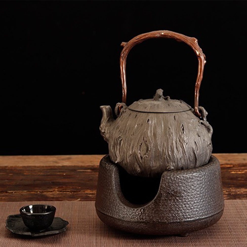 Close-up of Bodhidharma carving on Japanese cast iron teapot for tea brewing