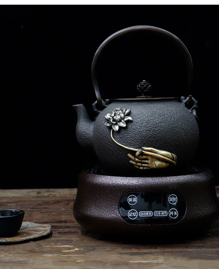 Lotus patterned cast iron teapot on a wooden table, perfect for serving tea.
