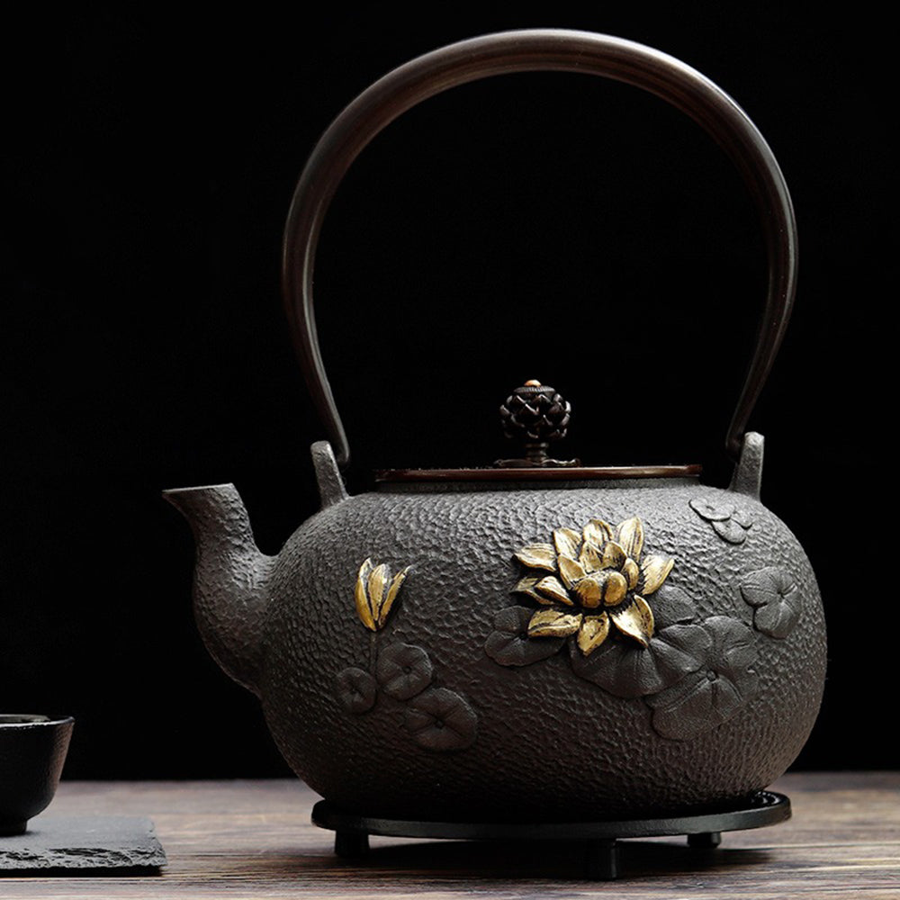 Top view of Japanese teapot with gold lotus design showing intricate detailing and copper handle