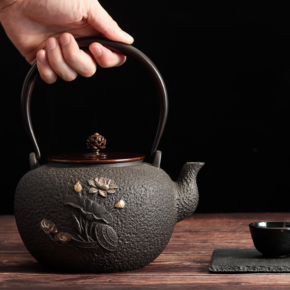Artisan Dragonfly Cast Iron Teapot with copper handle, beautifully crafted for tea brewing.