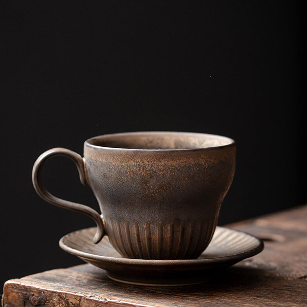 Close-up of the artisan Bizen-yaki tea cup with saucer highlighting its unique texture and color.