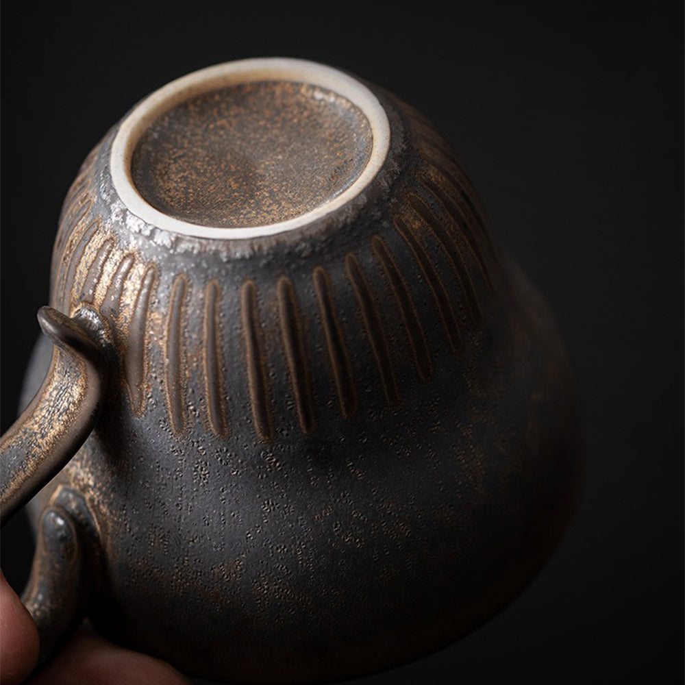 Close-up of the artisan Bizen-yaki tea cup with saucer highlighting its unique texture and color.