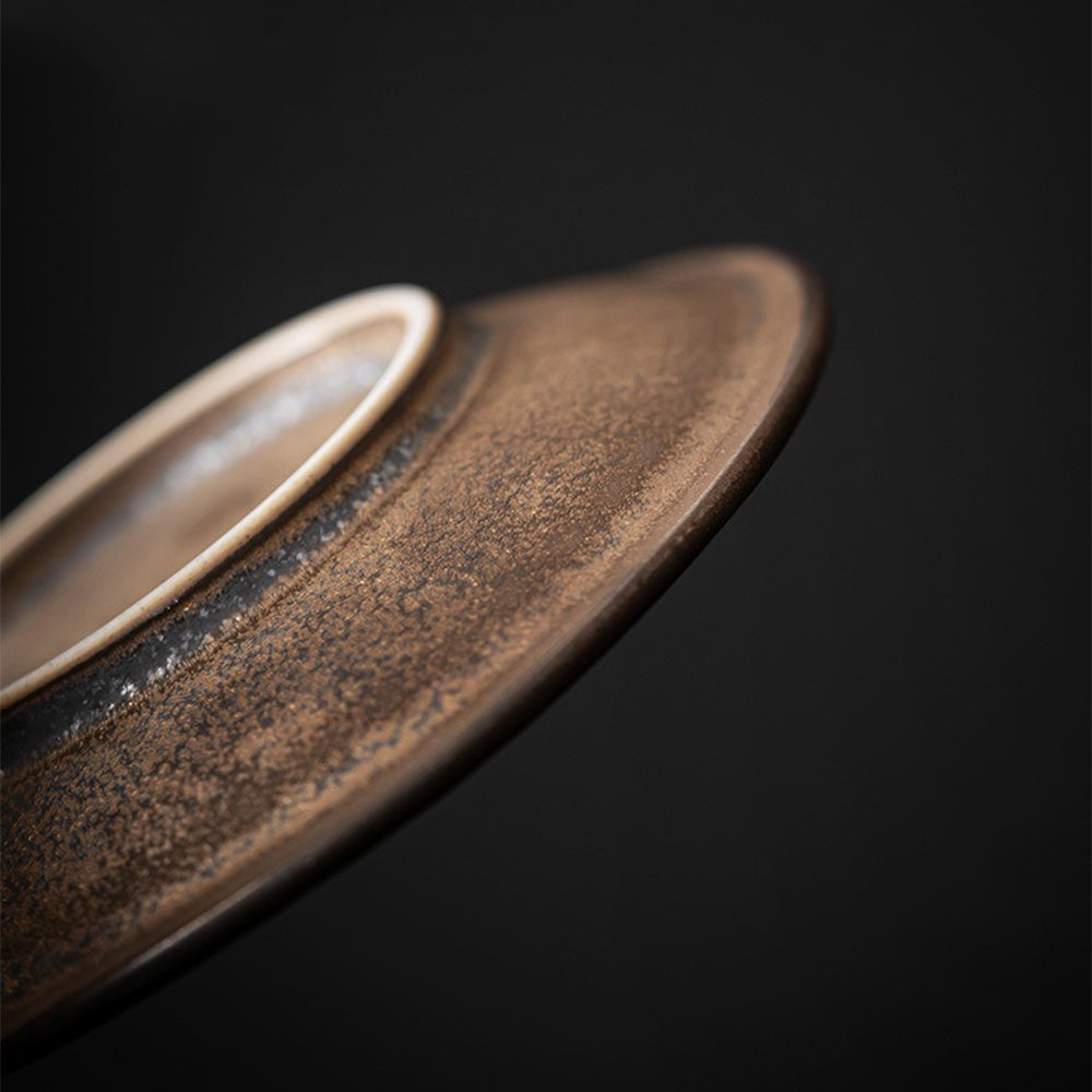 Elegant display of the Bizen-yaki tea cup with saucer, emphasizing its ergonomic handle and craftsmanship.
