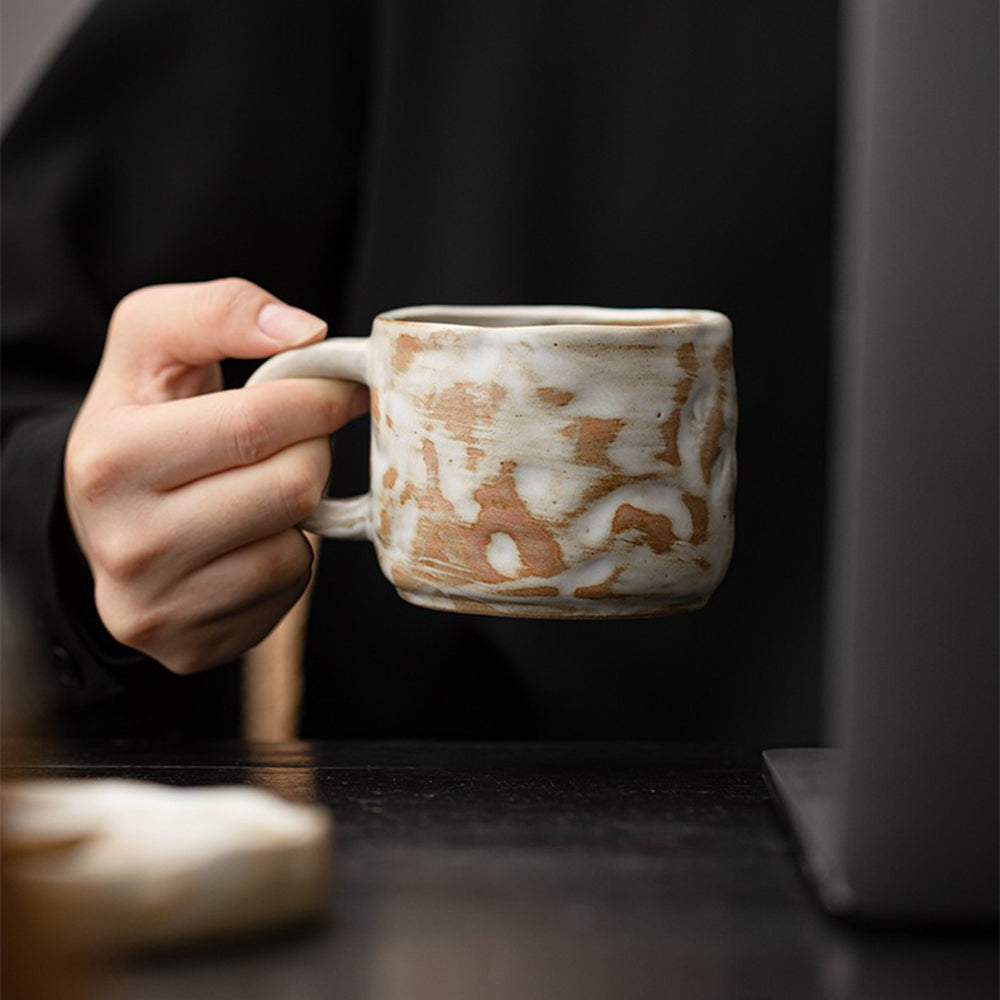 A side view of the microwave safe handmade coffee mug demonstrating its sturdy handle and frosted non-slip bottom.