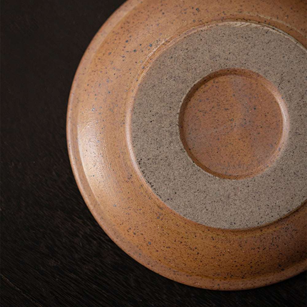 Side view of the handmade Japanese mug highlighting its irregular shape and sturdy handle