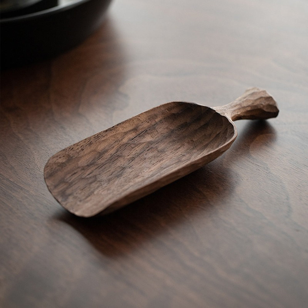 Close-up of hand carved walnut tea holder with intricate details for tea ceremonies