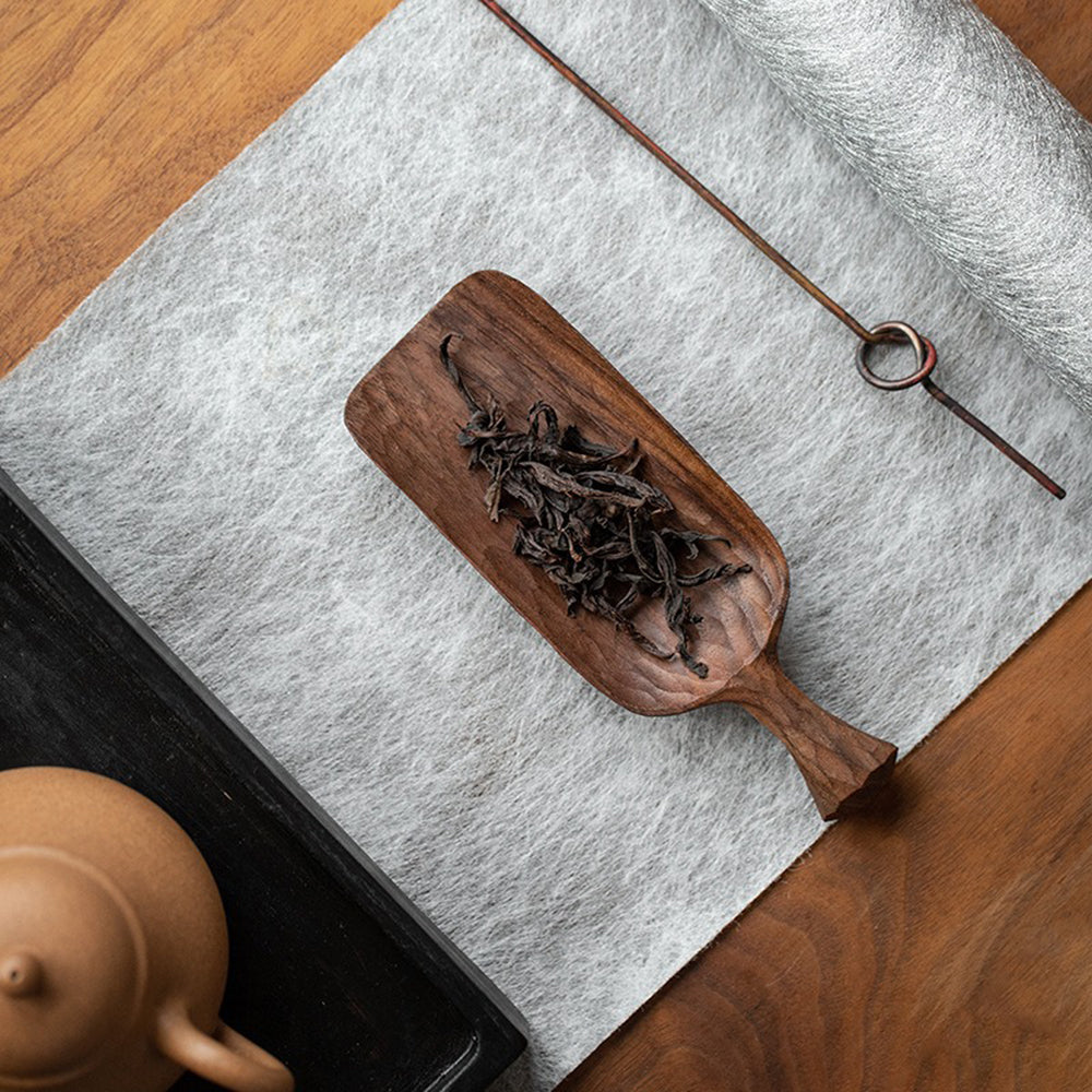 Close-up of hand carved walnut tea holder with intricate details for tea ceremonies
