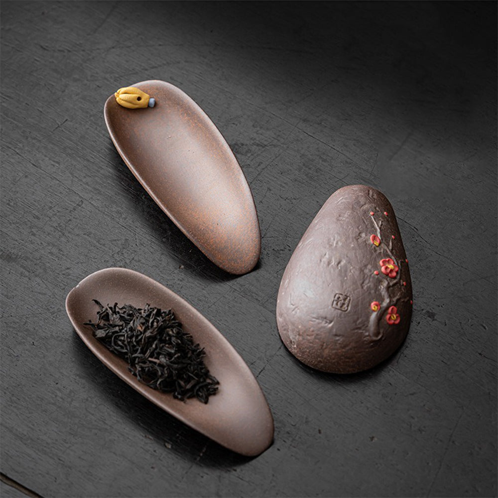 Elegant handmade clay tea holder showcasing the plum blossom relief design.