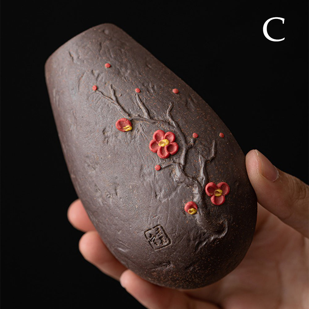 Elegant handmade clay tea holder showcasing the plum blossom relief design.