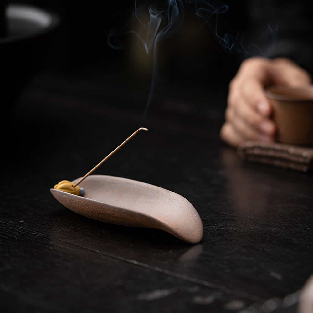 Buddhas Hand style clay tea holder with incense base functionality.