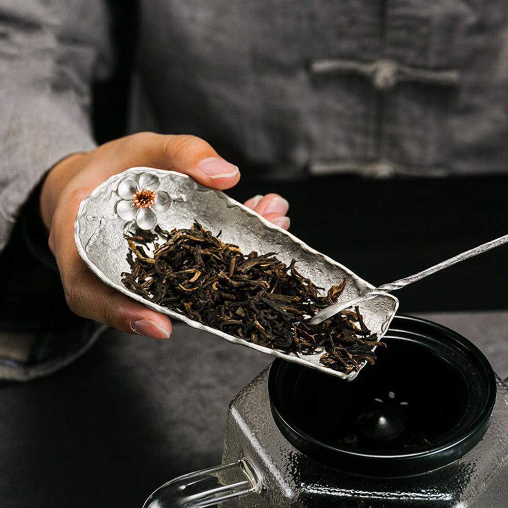 Complete tin tea set displayed on a wooden table, emphasizing its elegant craftsmanship.